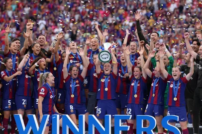 Barcelona's players celebrate with the trophy after winning the UEFA Women's Champions League final football match between FC Barcelona and Olympique Lyonnais at the San Mames stadium in Bilbao on May 25, 2024. (Photo by Pierre-Philippe MARCOU / AFP)<!-- NICAID(15773332) -->