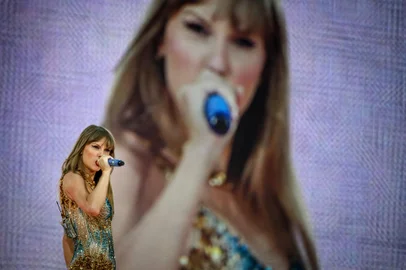 (FILES) US singer and songwriter Taylor Swift performs on stage at the Groupama Stadium as part of The Eras Tour, in Decines-Charpieu, eastern France, on June 2, 2024. Three shows in Vienna by the American mega-star have been cancelled after Austria arrested a man in connection with an Islamist attack plot, the organisers said on August 8, 2024. (Photo by JEFF PACHOUD / AFP) / -- IMAGE RESTRICTED TO EDITORIAL USE - STRICTLY NO COMMERCIAL USE --<!-- NICAID(15835386) -->