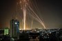 Rockets are launched from Gaza city, controlled by the Palestinian Hamas movement, in response to an Israeli air strike on a 12-storey building in the city, towards the coastal city of Tel Aviv, on May 11, 2021. (Photo by ANAS BABA / AFP)<!-- NICAID(14780190) -->