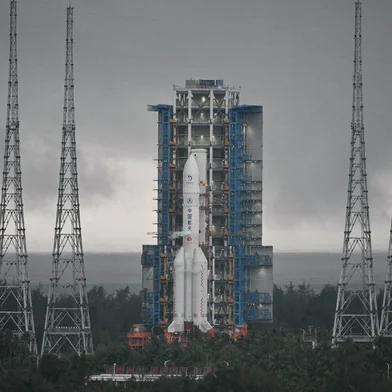 This picture shows a Long March 5 rocket, carrying the Chang'e-6 mission lunar probe, at the Wenchang Space Launch Centre in southern China's Hainan Province on May 3, 2024. China is set on May 3 to launch a probe to collect samples from the far side of the Moon, a world first as Beijing pushes ahead with an ambitious programme that aims to send a crewed lunar mission by 2030. (Photo by HECTOR RETAMAL / AFP)<!-- NICAID(15759325) -->
