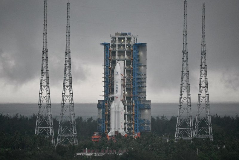 This picture shows a Long March 5 rocket, carrying the Chang'e-6 mission lunar probe, at the Wenchang Space Launch Centre in southern China's Hainan Province on May 3, 2024. China is set on May 3 to launch a probe to collect samples from the far side of the Moon, a world first as Beijing pushes ahead with an ambitious programme that aims to send a crewed lunar mission by 2030. (Photo by HECTOR RETAMAL / AFP)<!-- NICAID(15759325) -->