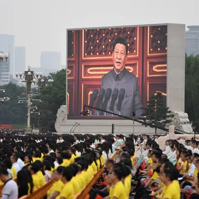 Chinese President Xi Jinping (on screen) delivers a speech during the celebrations of the 100th anniversary of the founding of the Communist Party of China at Tiananmen Square in Beijing on July 1, 2021. (Photo by WANG Zhao / AFP)<!-- NICAID(14823093) -->
