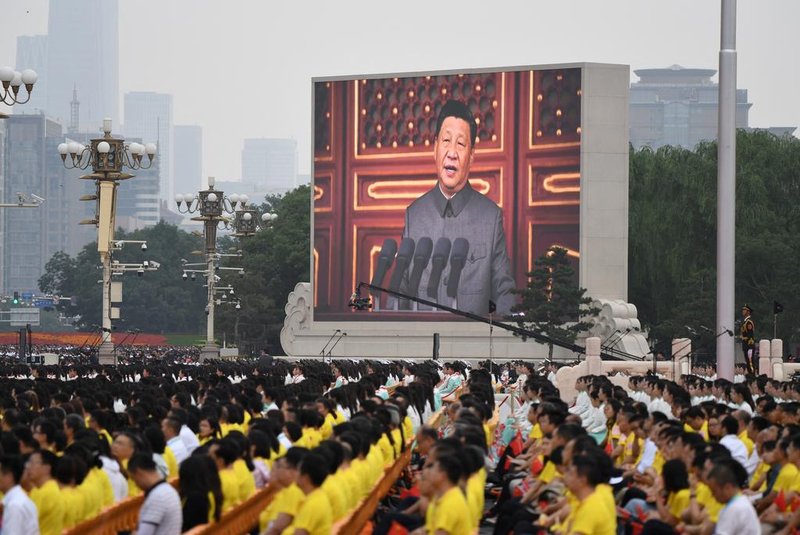 Chinese President Xi Jinping (on screen) delivers a speech during the celebrations of the 100th anniversary of the founding of the Communist Party of China at Tiananmen Square in Beijing on July 1, 2021. (Photo by WANG Zhao / AFP)<!-- NICAID(14823093) -->