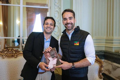 Christopher Goulart entrega seu livro "E Manchado de Sangue Terás que Crescer: uma Vida de Lutas" para o governador Eduardo Leite.<!-- NICAID(16102882) -->