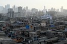 A general view of the Dharavi slums with high rise buildings seen in the background in Mumbai on March 16, 2024. (Photo by Indranil Mukherjee / AFP)<!-- NICAID(15709373) -->