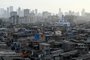 A general view of the Dharavi slums with high rise buildings seen in the background in Mumbai on March 16, 2024. (Photo by Indranil Mukherjee / AFP)<!-- NICAID(15709373) -->