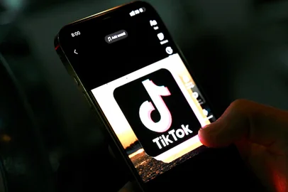 In this photo illustration taken on April 21, 2022, the icon of an video sharing mobile phone application TikTok is pictured on a mobile phone used by an Afghan youth in Kabul. - The Taliban ordered a ban against video-sharing app TikTok and the survival-shooter PlayerUnknown's Battlegrounds (PUBG) game on April 21, insisting they were leading Afghanistan's youth astray. (Photo by Wakil Kohsar / various sources / AFP)<!-- NICAID(15074964) -->
