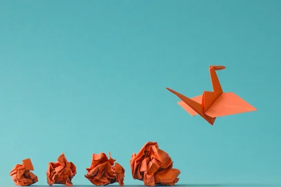 New ideas or transformation concept with crumpled paper balls and a crane, teamwork, creativity, business concept<!-- NICAID(15810057) -->