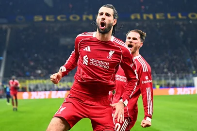 Liverpool's Hungarian midfielder #08 Dominik Szoboszlai celebrates scoring a penalty kick with Liverpool's Argentinian midfielder #10 Alexis Mac Allister during the UEFA Champions League phase day 6 football match between Inter Milan and Liverpool at San Siro stadium in Milan, on December 9, 2025. (Photo by Stefano RELLANDINI / AFP)<!-- NICAID(16183702) -->