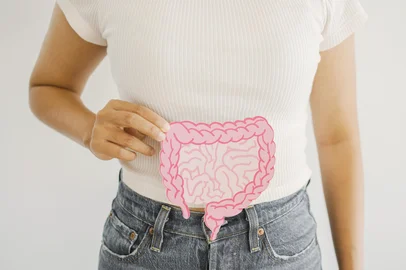 Woman hands holding intestine shape, healthy bowel digestion, leaky gut, probiotic and prebiotic for gut health, colon, gastric, stomach cancer concept<!-- NICAID(16259790) -->