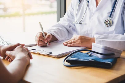 The doctor is discussing with the patient after a physical examination of the results and treatment guidelines.photobyphotoboy /  stock.adobe.com<!-- NICAID(15954238) -->