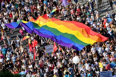 (FILES) In this file photo taken on July 06, 2019 people march with their giant rainbow flag during the lesbian, gay, bisexual and transgender (LGBT) Pride Parade from the parliament building in downtown Budapest. - Hungary's Prime Minister Viktor Orban said on July 21, 2021 that a referendum would be held to gauge domestic support for a controversial LGBTQ law, after the European Commission launched legal action against Budapest over the measure. (Photo by ATTILA KISBENEDEK / AFP)<!-- NICAID(14840460) -->