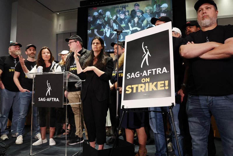 LOS ANGELES, CALIFORNIA - JULY 13: SAG-AFTRA President Fran Drescher (3rd L) speaks at a press conference announcing their strike against Hollywood studios on July 13, 2023 in Los Angeles, California. Members of SAG-AFTRA, Hollywoods largest union which represents actors and other media professionals, will join striking WGA (Writers Guild of America) workers at midnight in the first joint walkout against the studios since 1960. The strike could shut down Hollywood productions completely with writers in the third month of their strike against the Hollywood studios.   Mario Tama/Getty Images/AFP (Photo by MARIO TAMA / GETTY IMAGES NORTH AMERICA / Getty Images via AFP)<!-- NICAID(15482307) -->