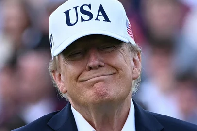 BRENDAN SMIALOWSKI / AFP US President Donald Trump waits to present the winner's trophy to Ireland's Shane Lowry (not pictured) following his victory on the final day of the Irish Open golf tournament at the Trump International Golf Links & Hotel, a resort and golf course owned by the president, in Doonbeg, western Ireland on September 13, 2026. (Photo by Brendan SMIALOWSKI / AFP)<!-- NICAID(16367243) -->