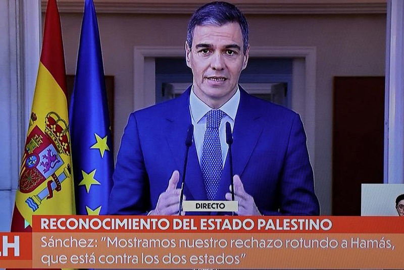 A picture of a TV screen taken on May 28, 2024 shows Spain's Prime Minister Pedro Sanchez delivering a speech over the recognition of Palestinian statehood by Spain, at La Moncloa Palace in Madrid. Recognising Palestinian statehood is 'essential for reaching peace' said Spain's Prime Minister Pedro Sanchez on May 28, 2024. Spain, Ireland and Norway will formally recognise a Palestinian state Tuesday in a decision slammed by Israel as a "reward" for Hamas more than seven months into the devastating Gaza war. (Photo by Thomas COEX / AFP)<!-- NICAID(15774869) -->