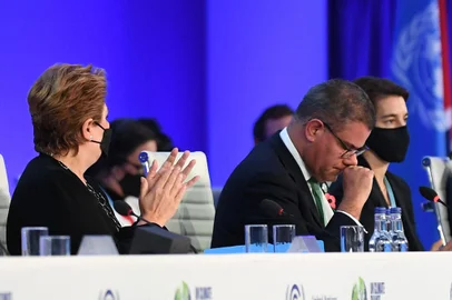 Britain's President for COP26 Alok Sharma (R) reacts as he makes his concluding remarks during the COP26 UN Climate Change Conference in Glasgow on November 13, 2021. (Photo by Paul ELLIS / AFP) <!-- NICAID(14940474) -->
