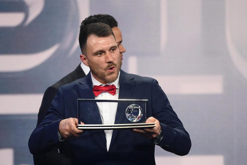 Warta Poznan's Polish player Marcin Oleksy delivers a speech after receiving the FIFA Puskas Award for best goal during the Best FIFA Football Awards 2022 ceremony in Paris on February 27, 2023. (Photo by FRANCK FIFE / AFP)<!-- NICAID(15361335) -->