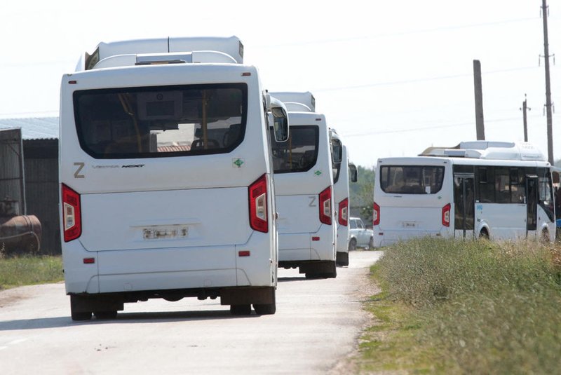 Buses drive on the road during the evacuation in the small town of Oktyabr'skoye near Simferopol, on July 22, 2023. A Ukrainian drone attack on Crimea Saturday blew up an ammunition depot, sparking evacuations on the Moscow-annexed peninsula and halting rail traffic, just five days after drones damaged Russia's symbolic bridge across the Kerch Strait. (Photo by STRINGER / AFP)<!-- NICAID(15489933) -->