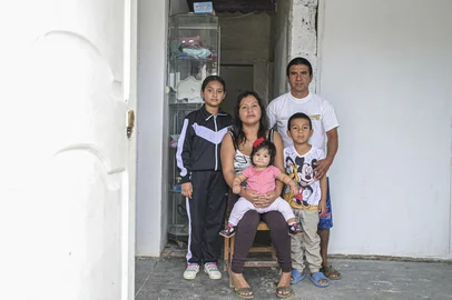 Sayuri Moreno, 37, and her family pose for a picture at their home in Huarmey, Anchash department, northern Peru, on May 25, 2024. In the slums of Huarmey, in the department of Ancash, where some 3,000 people live by the sea, the health authorities detected 120 cases of residents with high amounts of arsenic, among 140 tests carried out last year, according to the Ministry of Health.Inorganic arsenic is the major "chemical contaminant" in drinking water, according to the World Health Organization, which also classifies it as a carcinogen and one of the 10 most dangerous substances for public health. (Photo by ERNESTO BENAVIDES / AFP)<!-- NICAID(15815184) -->