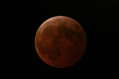 The full moon, also known as the "blood moon," is seen in Mexico City on March 13, 2025, during the lunar eclipse. (Photo by Yuri CORTEZ / AFP)<!-- NICAID(15995341) -->