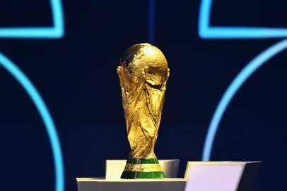 MANDEL NGAN / POOL/AFP The FIFA World Cup Trophy is displayed on a podium during the draw for the 2026 FIFA Football World Cup taking place in the US, Canada and Mexico, at the Kennedy Center, in Washington, DC, on December 5, 2025. (Photo by Mandel NGAN / POOL / AFP)<!-- NICAID(16181289) -->