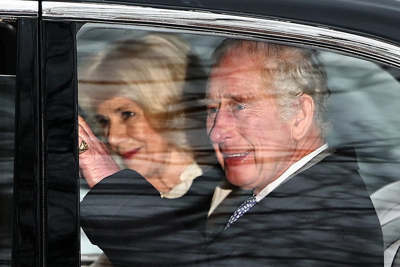 Britain's King Charles III and Britain's Queen Camilla wave as they leave by car from Clarence House in London on February 6, 2024. King Charles III's estranged son Prince Harry reportedly arrived in London on Tuesday after his father's diagnosis of cancer, which doctors "caught early". (Photo by HENRY NICHOLLS / AFP)Editoria: HUMLocal: LondonIndexador: HENRY NICHOLLSSecao: imperial and royal mattersFonte: AFPFotógrafo: STR<!-- NICAID(15671174) -->