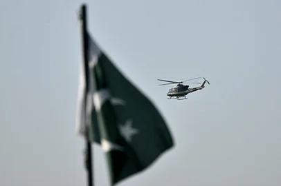 A helicopter flies over the Red Zone area of Islamabad on April 25, 2026. US envoys headed to the Pakistani capital on April 25 in a bid to kickstart a new round of peace negotiations with Iran amid a fragile ceasefire, though the prospect of direct talks remained uncertain.