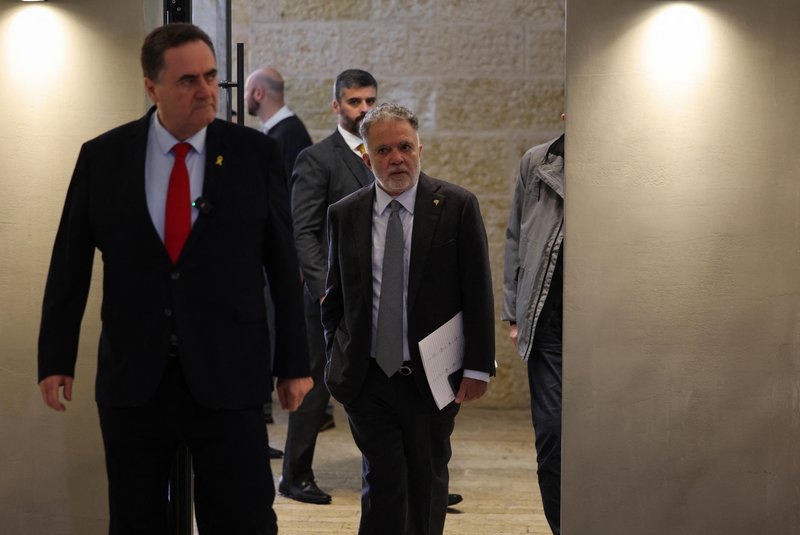 Brazil's Ambassador in Israel Frederico Meyer (C) visits the Yad Vashem Holocaust Memorial museum in Jerusalem, where he was summoned by Israel's Foreign Minister Israel Katz (L) in the presence of reporters on February 19, 2024. Brazil's President Luiz Inacio Lula Da Silva is not welcome in Israel until he apologises for comparing its ongoing war against Hamas to the Holocaust, the country's foreign minister said on February 19. (Photo by AHMAD GHARABLI / AFP)<!-- NICAID(15683538) -->