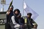 Taliban fighters stand on an armoured vehicle parade along a road to celebrate after the US pulled all its troops out of Afghanistan, in Kandahar on September 1, 2021 following the Talibans military takeover of the country. (Photo by JAVED TANVEER / AFP)<!-- NICAID(14879100) -->