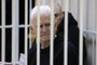 (FILES) In this file photo taken on January 05, 2023 Nobel Prize winner Ales Bialiatski is seen in the defendants' cage in the courtroom at the start of the hearing in Minsk. - A court in Belarus on March 3, 2023 sentenced Nobel Prize winner Ales Bialiatski to 10 years in prison, in a case his supporters see as punishment for his human rights work. The Viasna rights group founded by Bialiatski said in a statement that the 60-year-old had been convicted of smuggling and financing "activities that grossly violate public order". (Photo by Vitaly PIVOVARCHIK / BELTA / AFP) / Belarus OUT<!-- NICAID(15365333) -->