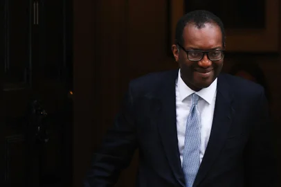 Britain's dismissed Chancellor of the Exchequer Kwasi Kwarteng walks out of Number 11 Downing Street in central London on October 14, 2022. - British Prime Minister Liz Truss dismissed her finance minister, forcing Kwasi Kwarteng to carry the can for turmoil sparked by her right-wing economic platform as restive Conservatives plotted her own demise. (Photo by ISABEL INFANTES / AFP)<!-- NICAID(15235766) -->
