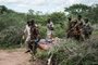 Security personnel carry a rescued young person from the forest in Shakahola, outside the coastal town of Malindi, on April 23, 2023. - Twenty-one bodies have been exhumed in Kenya while investigating a cult whose followers are believed to have starved themselves to death, police sources said on April 22, 2023, warning the toll could rise. (Photo by Yasuyoshi CHIBA / AFP)<!-- NICAID(15410501) -->