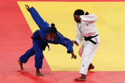 France's Clarisse Agbegnenou and Brazil's Ketleyn Quadros (Blue) compete in the judo women's -63kg round of 15 bout of the Paris 2024 Olympic Games at the Champ-de-Mars Arena, in Paris on July 30, 2024. (Photo by Jack GUEZ / AFP)<!-- NICAID(15826512) -->