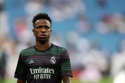 (FILES) Real Madrid's Brazilian forward Vinicius Junior warms up prior to the Spanish league football match between Real Madrid CF and Athletic Club Bilbao at the Santiago Bernabeu stadium in Madrid on June 4, 2023. Rio de Janeiro's legislative assembly on June 6, 2023, approved a bill that provides for the interruption or suspension of football matches in cases of racism, in the first concrete action in Brazil following the wave of outrage over racist behaviour towards Brazilian Vinicius Jr. in Spain. (Photo by Pierre-Philippe MARCOU / AFP)<!-- NICAID(15458589) -->