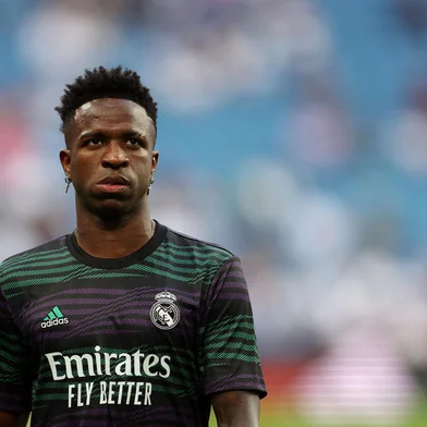 (FILES) Real Madrid's Brazilian forward Vinicius Junior warms up prior to the Spanish league football match between Real Madrid CF and Athletic Club Bilbao at the Santiago Bernabeu stadium in Madrid on June 4, 2023. Rio de Janeiro's legislative assembly on June 6, 2023, approved a bill that provides for the interruption or suspension of football matches in cases of racism, in the first concrete action in Brazil following the wave of outrage over racist behaviour towards Brazilian Vinicius Jr. in Spain. (Photo by Pierre-Philippe MARCOU / AFP)<!-- NICAID(15458589) -->