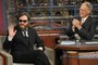 In this photo released by CBS, actor Joaquin Phoenix, left, waives to the audience from the set of the "The Late Show with David Letterman," in New York, Wednesday, Feb. 11, 2009 as host David Letterman watches from the desk. (CBS, J.P. Flio)<!-- NICAID(15054862) -->