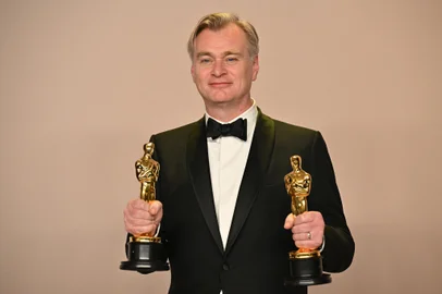 British director Christopher Nolan poses in the press room with the Oscars for Best Director and Best Picture for "Oppenheimer" during the 96th Annual Academy Awards at the Dolby Theatre in Hollywood, California on March 10, 2024. (Photo by Robyn BECK / AFP)<!-- NICAID(15701680) -->