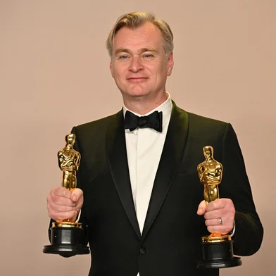 British director Christopher Nolan poses in the press room with the Oscars for Best Director and Best Picture for "Oppenheimer" during the 96th Annual Academy Awards at the Dolby Theatre in Hollywood, California on March 10, 2024. (Photo by Robyn BECK / AFP)<!-- NICAID(15701680) -->