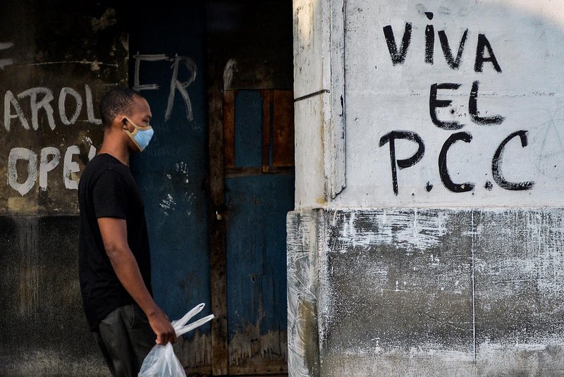 A man wearing a face mask walks by a graffiti reading "Long Live Cuba's Communist Party (PCC)" in Havana, on April 19, 2021, as the 8th Congress of the Cuban Communist Party (PCC) is being held in the island nation. - Delegates of Cuba's Communist Party elected a new Central Committee on Sunday, with an announcement due Monday on leadership as its historic congress closes with a sendoff for chief Raul Castro. When the 89-year-old Castro steps down as first secretary of the Communist Party -- the most powerful position in Cuba -- it will end a nearly six-decade family hold on power that started in 1959 under his revolutionary brother, Fidel, who died in 2016. (Photo by Yamil LAGE / AFP)<!-- NICAID(14761150) -->