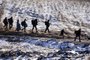 Migrants and refugees walk along snow covered fields after crossing the Macedonian border into Serbia, near the village of Miratovac, on January 19, 2016. More than one million migrants reached Europe in 2015, most of them refugees fleeing war and violence in Afghanistan, Iraq and Syria, according to the United Nations refugee agency.Editoria: POLLocal: MiratovacIndexador: DIMITAR DILKOFFSecao: migrationFonte: AFPFotógrafo: STF<!-- NICAID(11958318) -->