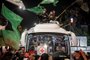 A crowd surrounds a Red Cross bus carrying Palestinians prisoners released from Israeli jails in exchange for hostages released by Hamas from the Gaza Strip, in Ramallah in the occupied West Bank on November 26, 2023. Israel's prison service said 39 Palestinian detainees were released on November 26, 2023 under the terms of a truce agreement between Israel and Hamas in the Gaza Strip. The announcement came after 13 Israeli hostages were freed in the Palestinian territory under the deal, along with three Thais and a Russian-Israeli dual citizen. (Photo by Fadel SENNA / AFP)<!-- NICAID(15609569) -->