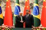 Chinese President Xi Jinping (R) and Brazil's President Luiz Inacio Lula da Silva shake hands after a signing ceremony at the Great Hall of the People in Beijing on April 14, 2023. (Photo by Ken Ishii / POOL / AFP)<!-- NICAID(15402736) -->