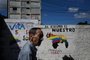 A man walks by a mural campaigning for a referendum to ask Venezuelans to consider annexing the Guyana-administered region of Essequibo, in 23 de Enero neighbourhood in Caracas on November 28, 2023. Venezuela is scheduled to hold a controversial referendum on December 3, to annex a disputed oil-rich territory administered by neighbouring Guyana. The government of Nicolas Maduro has organized the poll to ask Venezuelans to consider annexing the Essequibo region, which makes up two-thirds of tiny Guyana but is claimed by Caracas. (Photo by Federico PARRA / AFP)<!-- NICAID(15613868) -->