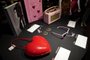 Accessories including earrings, heart-shaped sunglasses and purse are displayed during the New York press and public exhibition  of the "Property From The Life And Career Of Amy Winehouse" by Julien's Auctions in New York, October 11, 2021. - Dozens of dresses, including the famous one Amy Winehouse wore during her dramatic last concert in 2011, books, records, bags and objects that belonged to the British soul diva who died ten years ago will be auctioned in California in November. The US exhibition Tour will be at Hard Rock Cafe New York October 11-17, before the two-day auction event taking place live November 6 and 7. (Photo by TIMOTHY A. CLARY / AFP)<!-- NICAID(14912713) -->