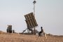 A boy rides a donkey near one of the batteries of Israel's Iron Dome missile defence system at a village not recognised by Israeli authorities in the southern Negev desert on April 14, 2024. (Photo by AHMAD GHARABLI / AFP)<!-- NICAID(15735199) -->
