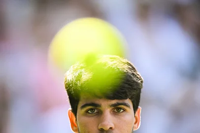 Spain's Carlos Alcaraz eyes the ball as he plays against Italy's Jannik Sinner during their men's singles final tennis match on the fourteenth day of the 2025 Wimbledon Championships at The All England Lawn Tennis and Croquet Club in Wimbledon, southwest London, on July 13, 2025. (Photo by Kirill KUDRYAVTSEV / AFP) / RESTRICTED TO EDITORIAL USE<!-- NICAID(16079399) -->