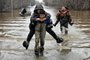 A picture taken on April 8, 2024 shows rescuers evacuating residents from the flooded part of the city of Orsk, Russia's Orenburg region, southeast of the southern tip of the Ural Mountains. Russia said on April 8, 2024 that more than 10,000 residential buildings were flooded across the Urals, Volga area and western Siberia as emergency services evacuated cities threatened by rising rivers. On April 7, Russia declared a federal emergency in the Orenburg region, where the Ural river flooded much of the city of Orsk and is now reaching dangerous levels in the main city of Orenburg. Much of the city of Orsk has been flooded after torrential rain burst a nearby dam. (Photo by Anatoliy ZHDANOV / Kommersant Photo / AFP) / Russia OUT<!-- NICAID(15728333) -->