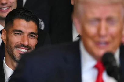Inter Miami's Uruguayan forward Luis Suarez smiles as he listen to US President Donald Trump speak during an event honoring the winners of the 2025 Major League Soccer Cup, in the East Room of the White House in Washington, DC, on March 5, 2026. (Photo by ANDREW CABALLERO-REYNOLDS / AFP)<!-- NICAID(16239272) -->