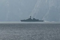 A navy vessel is seen sailing in the Strait of Hormuz, a vital waterway through which much of the world's oil and gas passes on March 1, 2026. Two ships were attacked in the Strait of Hormuz on March 1, maritime security agencies said, as Iran pressed a second day of strikes in response to US-Israeli military strikes on Iran killing it's supreme leader. (Photo by Sahar AL ATTAR / AFP)<!-- NICAID(16236644) -->