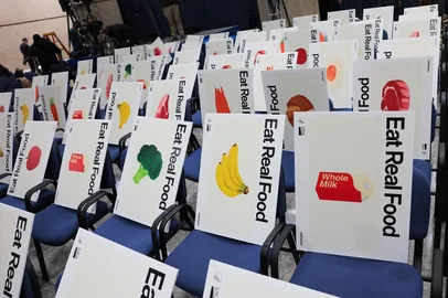 WASHINGTON, DC - JANUARY 08: Posters of food and beverages line the seats ahead of a policy announcement event at the U.S. Department of Health and Human Services on January 8, 2026 in Washington, DC. The Trump administration announced new dietary guidelines on Wednesday including an emphasis on proteins and full-fat dairy, and limits on processed foods.   Anna Moneymaker/Getty Images/AFP (Photo by Anna Moneymaker / GETTY IMAGES NORTH AMERICA / Getty Images via AFP)<!-- NICAID(16203318) -->